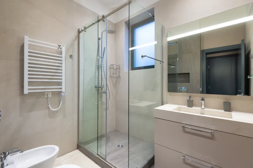 Minimalist bathroom featuring frameless glass shower and sleek vanity designed by Builders Silverdale expert in bathroom renovations