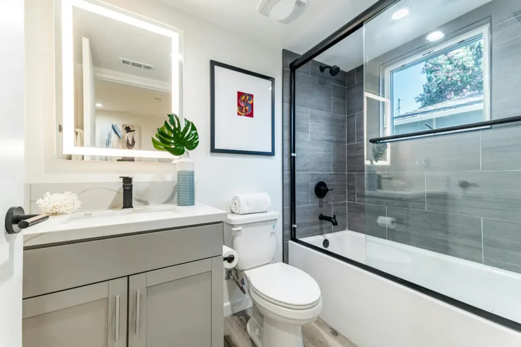 Contemporary bathroom remodel with bathtub and vanity by Builders Silverdale showcasing stylish bathroom renovations