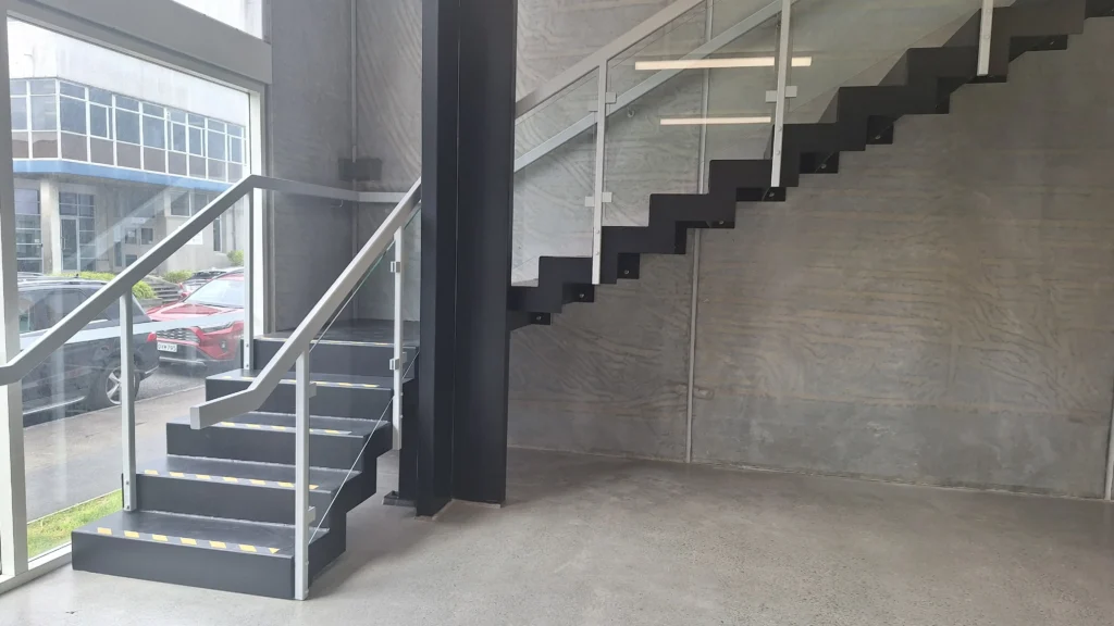 Industrial-style staircase inside a modern commercial space constructed by Builders Silverdale, expert builders silverdale