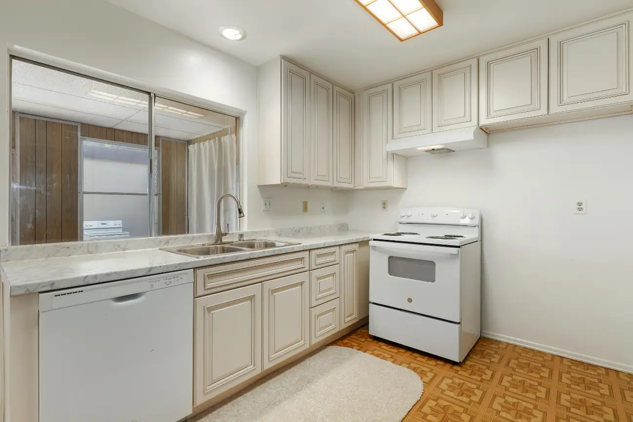 Traditional kitchen with white cabinetry and patterned flooring designed by Builders Silverdale expert in kitchen renovations
