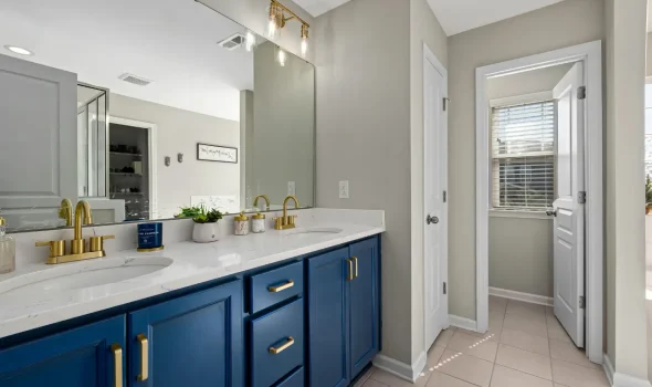 Stylish Bathroom Interior by Builders Silverdale Double vanity bathroom with blue cabinetry and gold fixtures designed by Builders Silverdale showcasing premium bathroom renovations