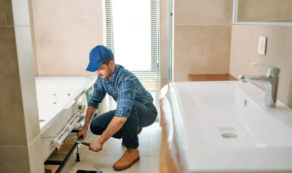 In Progress Bathroom Renovation by Builders Silverdale Builder working on bathroom plumbing during renovation handled by expert bathroom renovations team at Builders Silverdale