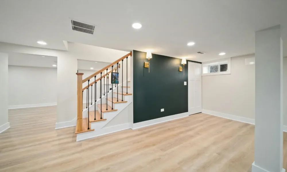 Freshly renovated basement space with light flooring and accent wall by Builders Silverdale expert in home renovations